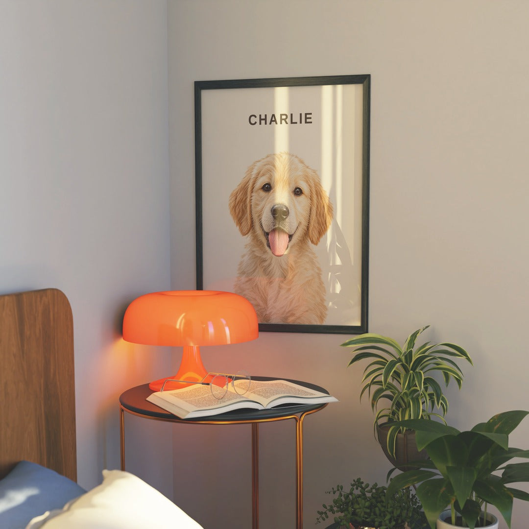Custom portrait of a golden retriever puppy named Charlie in a black frame by a bedside lamp